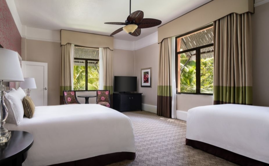 A room with two sets of double beds