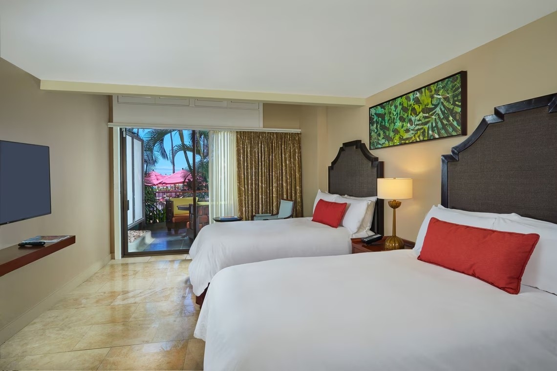 A room with two sets of double beds