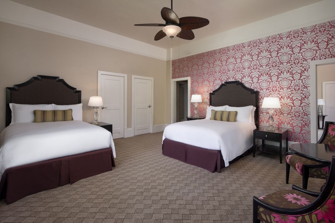 A room with two sets of double beds
