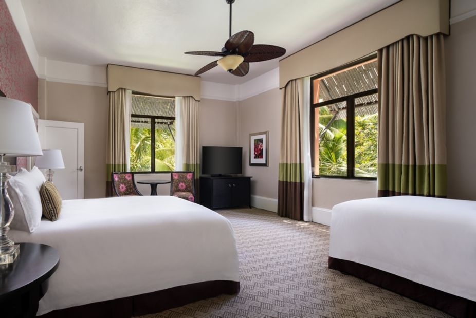 A room with two sets of double beds