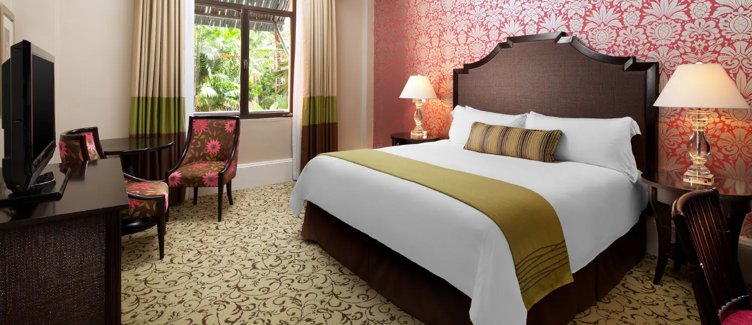 King-bed Historic Garden Room with a lush garden view at The Royal Hawaiian.