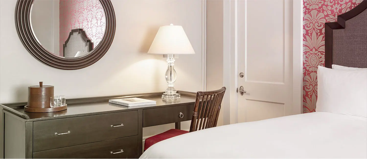 Writing desk and mirror inside the Historic Garden Room with refined décor.