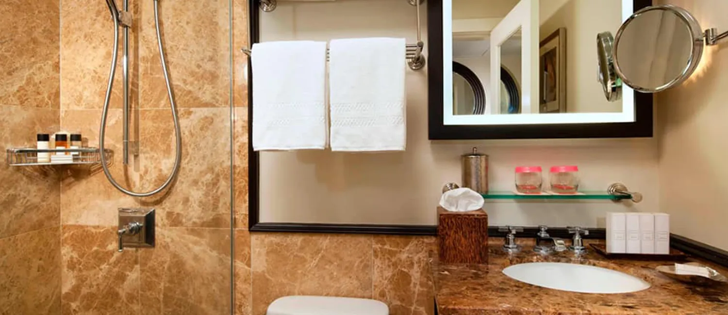 Bathroom featuring shower and vanity area with Malie Organics amenities.