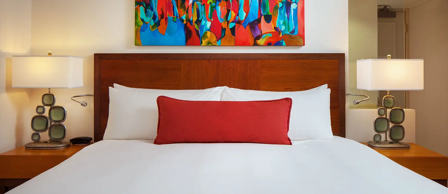 Bedroom featuring striking artwork above the headboard.