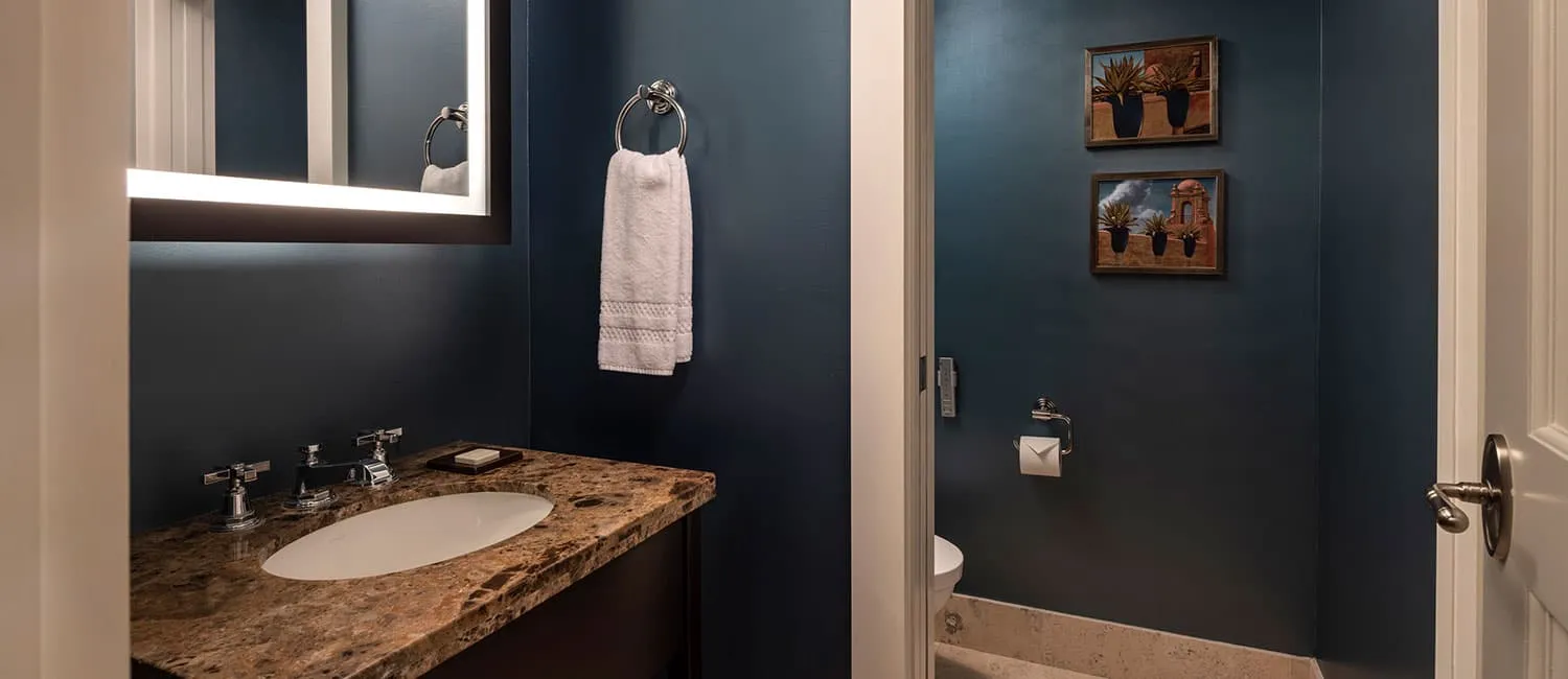 Powder room with deep navy walls creating a calm atmosphere.