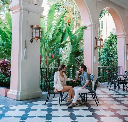 Photo of two people sitting at the Coconut Lanai