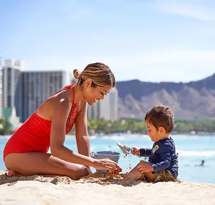 Photo of a woman and child playing at Waikiki Beach