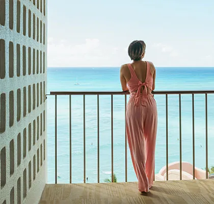Photo of a lady standing on the balcony