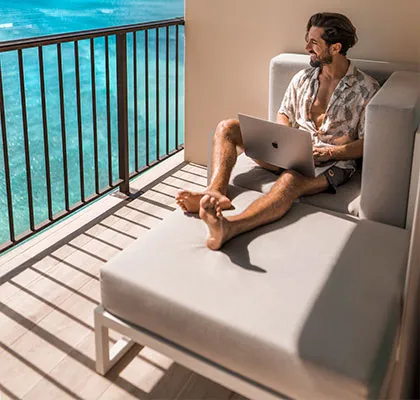 Photo of a man relaxing on the balcony sofa